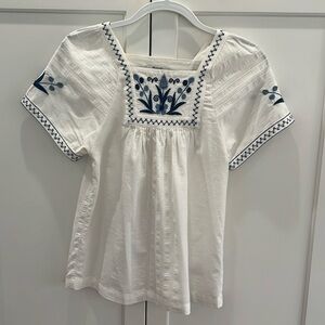 Women’s Madewell size XS white short sleeve shirt with blue embroidery.